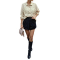 Women's blouse featuring stylish tassel details